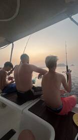 A group of friends enjoys a fishing trip at sunset, creating lasting memories on the water. Perfect for family bonding and outdoor adventures.