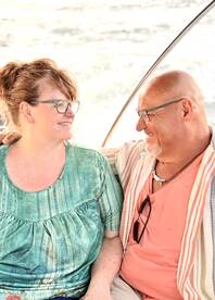 A happy couple shares a moment on a boat, showcasing the joy of romantic outings on the water.