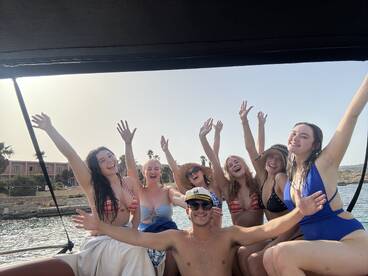 A lively group of friends celebrates on a boat, enjoying the sun and each other's company — perfect for summer outings and memorable adventures on the water.