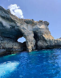 A stunning view of a natural rock arch against the vibrant blue waters, showcasing the breathtaking coastal scenery perfect for sightseeing and exploration.