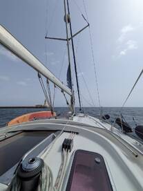 A view from the deck of a sailboat, showcasing the mast and rigging against a clear sky, perfect for sailing enthusiasts and maritime adventures.