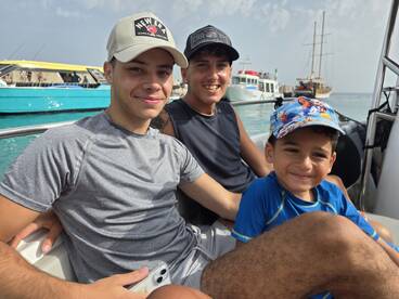 A joyful family moment aboard a boat, showcasing smiles and togetherness — perfect for capturing the essence of fun on the water.