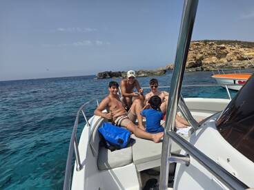 A joyful group enjoys a sunny day on the boat, creating lasting memories while relaxing and having fun in the beautiful waters.