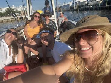 A lively group enjoys a fun day on the water, capturing memories aboard a fishing boat — perfect for friends looking to relax and celebrate together.