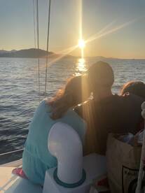 A couple enjoys a romantic moment watching the sunset from their boat, creating a perfect backdrop for memorable experiences on the water.