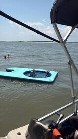 Children enjoy a fun day swimming on a floating mat in the water, showcasing a perfect summer activity for families.