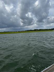 A cloudy scene over water with unclear visibility, lacking identifiable subjects or activities.