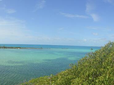 A stunning view of turquoise waters and a serene coastline, perfect for showcasing the natural beauty of the Bahamas.