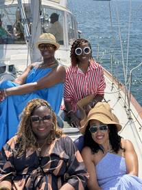 A joyful group of friends enjoys a sunny day sailing, showcasing the perfect atmosphere for celebrations and memorable outings on the water.