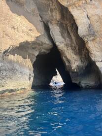 A stunning view of a cave entrance with crystal-clear waters, perfect for exploration and adventure on the water.
