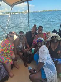 A joyful group of friends enjoys a fun day on the boat, capturing memories and celebrating together on the water.