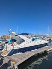 A stunning Fairline yacht docked at the marina, showcasing its sleek design against a clear blue sky — perfect for luxury boating experiences.