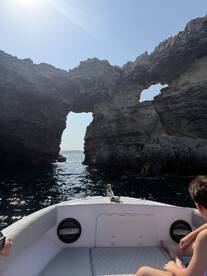 A scenic view of a boat navigating through a stunning rock formation, perfect for exploration and adventure on the water.