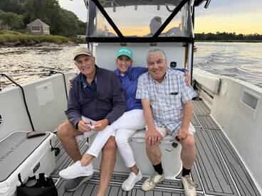 A joyful group of friends relaxes on a boat, enjoying their time together on the water — perfect for memorable outings and celebrations.