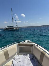 A serene view of a yacht anchored in clear blue waters, showcasing the beauty of a day on the water.