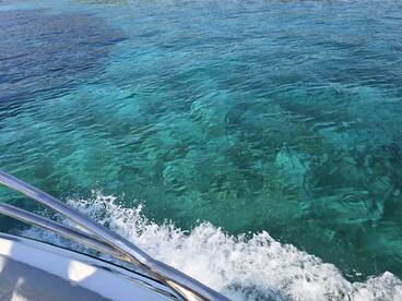 Captain Bruno manœuvres through crystalline waters