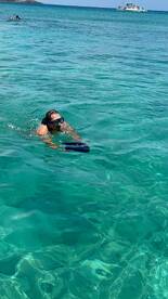 A snorkeler explores the vibrant underwater world in crystal-clear waters, showcasing the excitement of aquatic adventures.