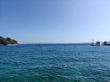 A scenic view of calm waters and distant land, showcasing a peaceful maritime environment.