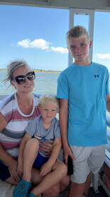 A family enjoys a day on the boat, capturing a moment with two children, perfect for creating lasting memories on the water.