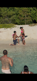 A heartfelt beach proposal unfolds as a couple celebrates their love in front of family, creating a memorable moment on the shore.
