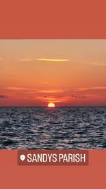 A stunning sunset over the ocean near Sandys Parish, creating a picturesque backdrop perfect for romantic evenings or tranquil boat rides.
