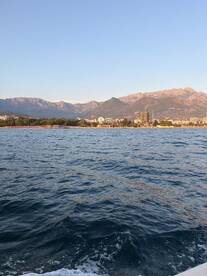 A stunning view of the coastline with mountains in the background, showcasing the natural beauty of the area — perfect for scenic boat trips.
