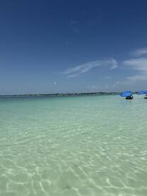 A serene view of clear waters and blue skies, capturing the essence of a tropical getaway.