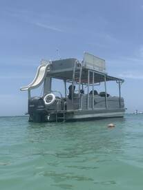 A fun-filled day on a pontoon boat with a child enjoying the water, showcasing the perfect setting for family adventures and water activities.
