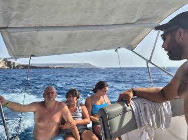 A family enjoys a boat ride, capturing the essence of summer fun on the water. The scenic backdrop enhances their memorable experience.
