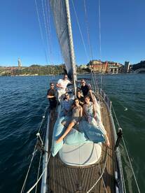 A cheerful group of friends enjoys a sailing adventure on a yacht, capturing the essence of fun and camaraderie on the water.