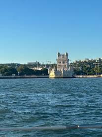 A picturesque view of the iconic Belem Tower in Lisbon, framed by the shimmering waters, perfect for capturing the essence of coastal sightseeing.