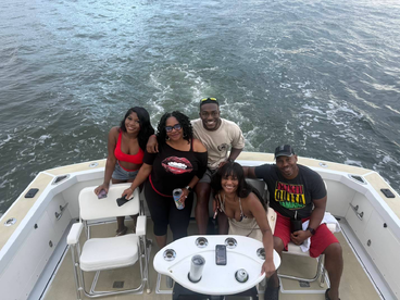 A lively group enjoys their time on a boat, capturing the essence of fun and celebration on the water.