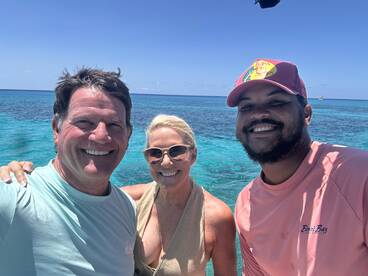 A cheerful group poses for a selfie in the stunning turquoise waters, capturing a memorable moment during their snorkeling adventure.
