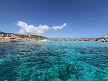 A stunning view of crystal-clear turquoise waters and a picturesque coastline, perfect for showcasing the beauty of a boating adventure.