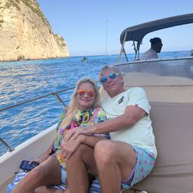 A couple enjoys a relaxing moment on a boat, surrounded by stunning ocean views — perfect for romantic getaways or leisurely days on the water.
