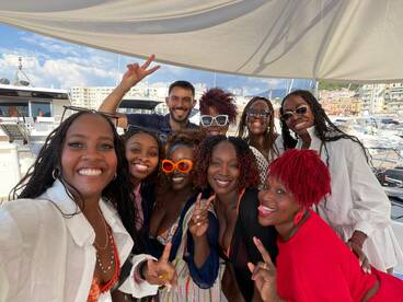 A joyful group of friends poses for a selfie aboard a yacht, capturing the essence of celebration and camaraderie on the water.