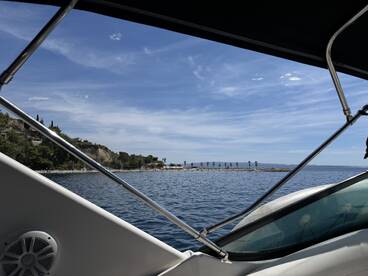 A picturesque view from a boat showcasing a beautiful coastline and harbor, perfect for enjoying serene moments on the water.