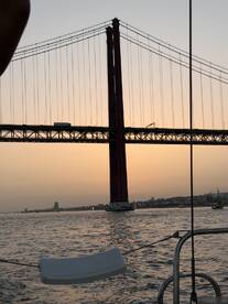 A stunning sunset view from a boat featuring the iconic bridge, creating a picturesque backdrop for a memorable boating experience.