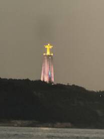 A distant view of a lit monument at night, partially obscured, creating an unclear image. Ideal for showcasing nighttime scenery.