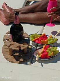 A refreshing spread of fruit and champagne on a boat, perfect for enjoying sunny days on the water.