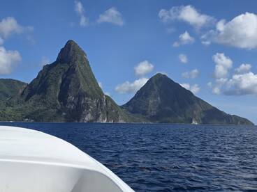 A stunning view of the iconic Pitons in St. Lucia, showcasing the breathtaking coastline and vibrant blue waters — perfect for island-hopping adventures.