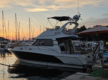 A beautiful yacht docked at sunset, surrounded by other boats in the marina — perfect for evening cruises and relaxation.