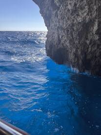 A stunning view of sparkling blue waters against a rocky cliff, capturing the beauty of ocean scenery — perfect for nature lovers and adventure seekers.