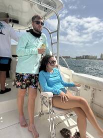 A couple enjoys a sunny day on a boat, capturing the essence of relaxation and fun on the water.