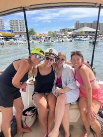 A fun group of friends poses together on a boat, enjoying a day out on the water — perfect for celebrations and memorable outings.