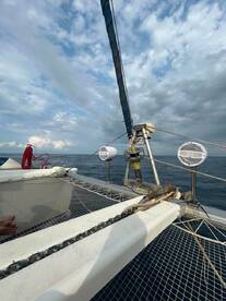 A close-up view of the interior of a catamaran, showcasing the helm and seating area, perfect for enjoying a day on the water.