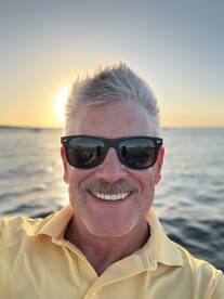 A joyful selfie taken at sunset on the water, capturing the essence of a perfect boating experience.