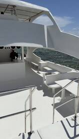 An interior view of a spacious boat cabin featuring seating and a helm area, perfect for relaxing while cruising on the water.