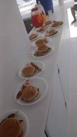 A delicious spread of burgers and snacks laid out on a boat, perfect for catering during a fun day on the water.