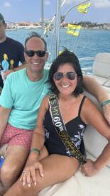 A couple celebrates a special birthday aboard a boat, showcasing joy and togetherness on the water.